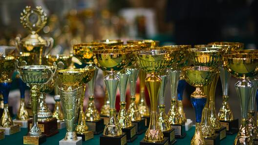 Collection of golden trophies awarded at betta fish shows and competitions.