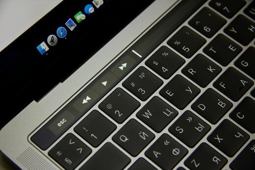 Close-up of a laptop keyboard with a dark screen